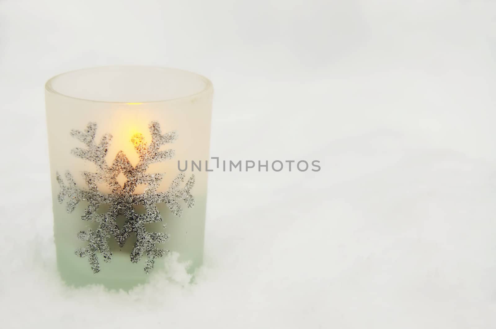 A single candlelight in the snow