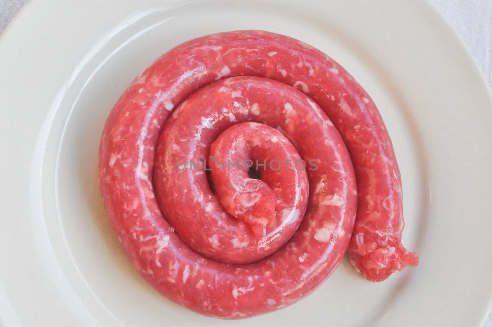 Detail of beef sausage in a dish