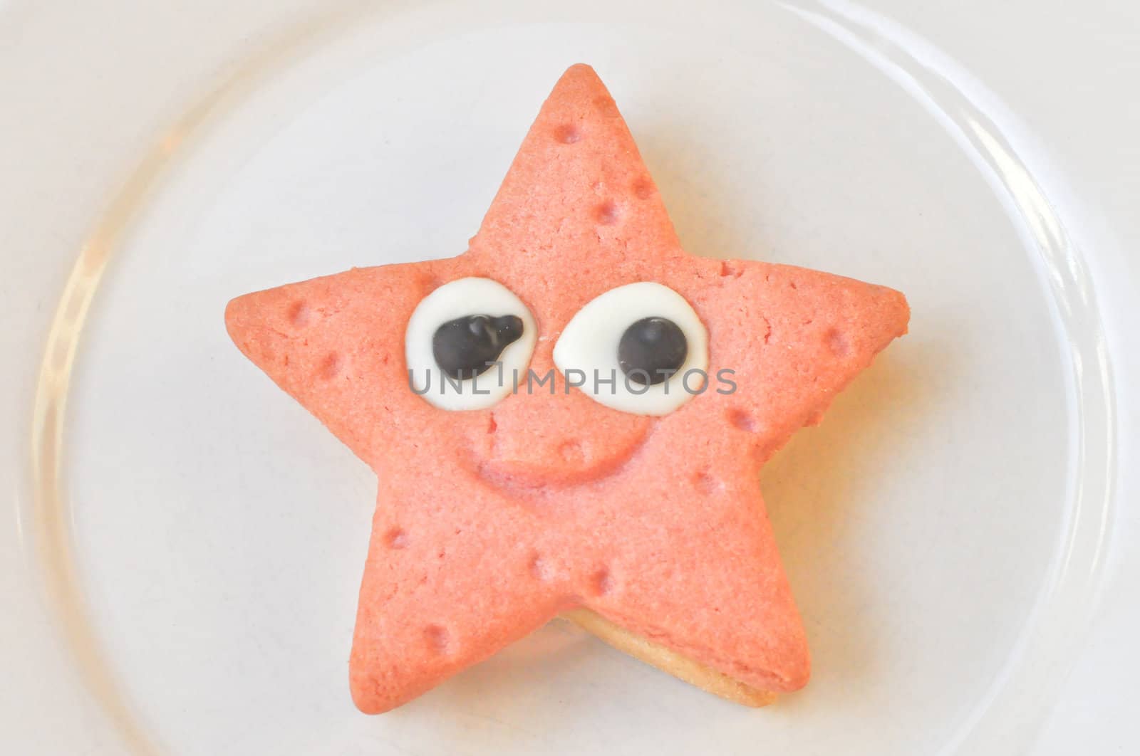 Home made star shaped strawberry and vanilla chocolate cookie in a dish