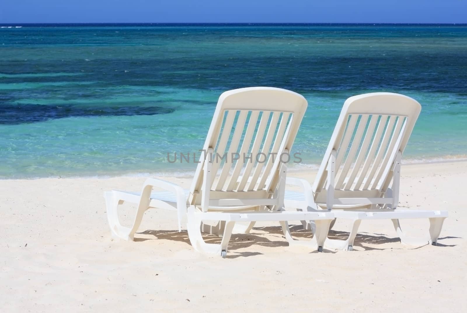 Sun loungers facing the Caribbean Sea