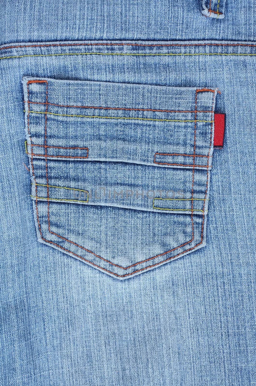 Rear blue denim jeans pocket with colourful stitches.