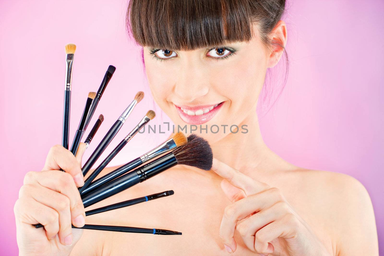 woman holding set of make up brushes by imarin