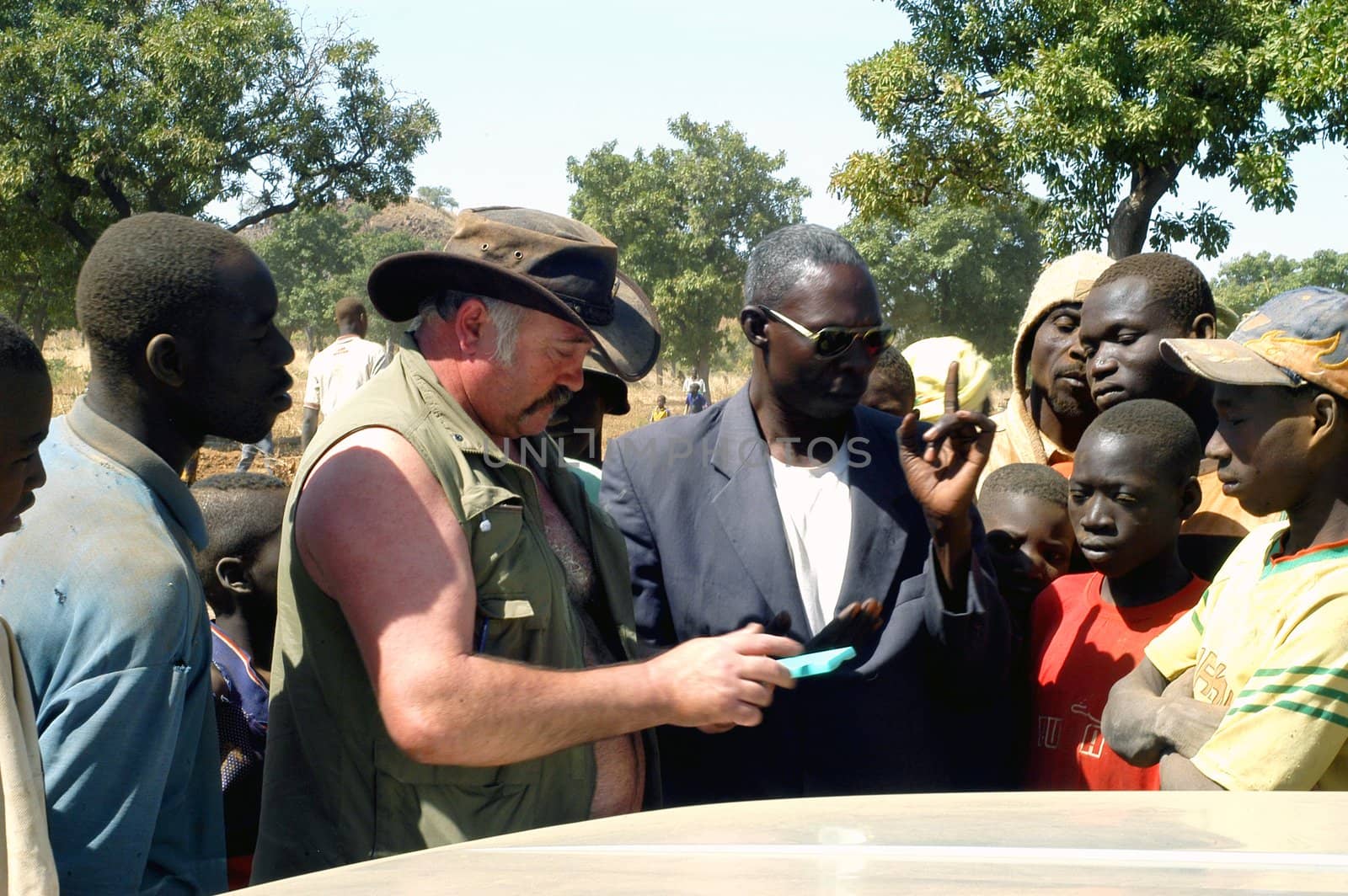 At the goldmine of Poura a French arrived and seeks to buy gold nuggets at the best price. Discussed are sharp and the cap of the car serves as office. The minors encircles the white man.                               