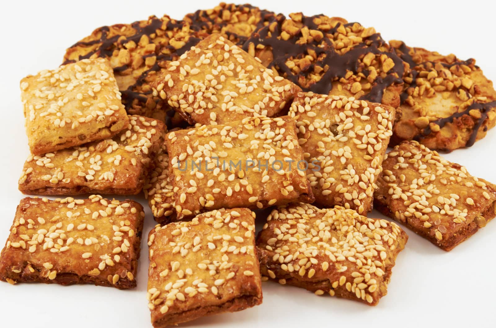A handful of cookies with peanuts and sesame seeds