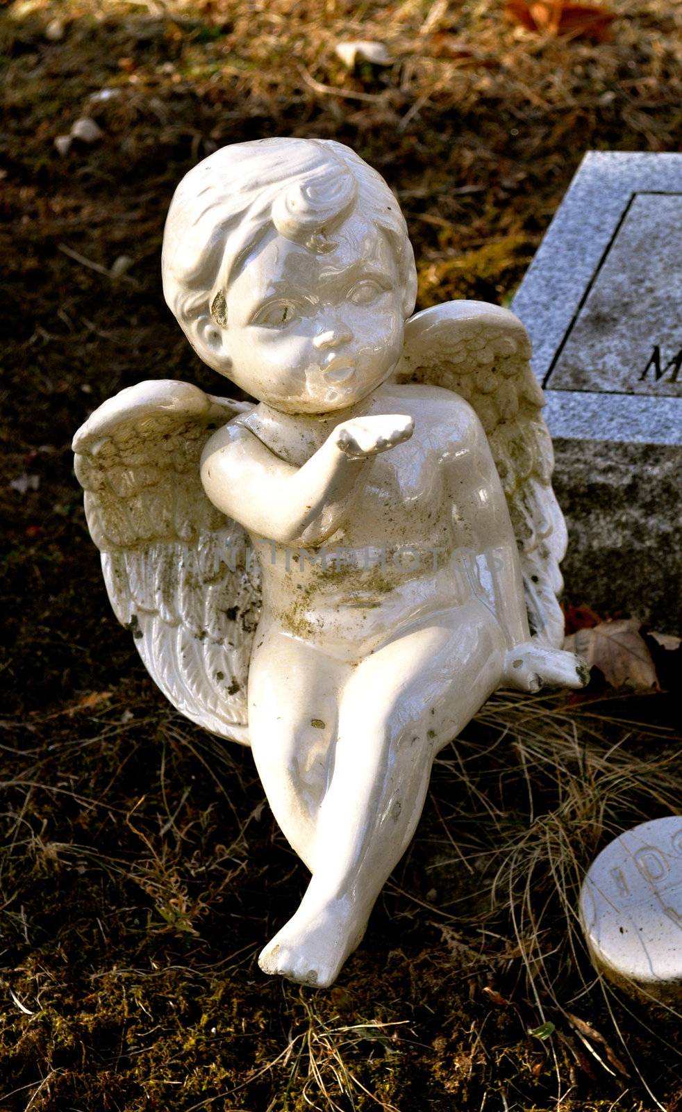 Gravesite - Cherub blowing a kiss - background  by RefocusPhoto