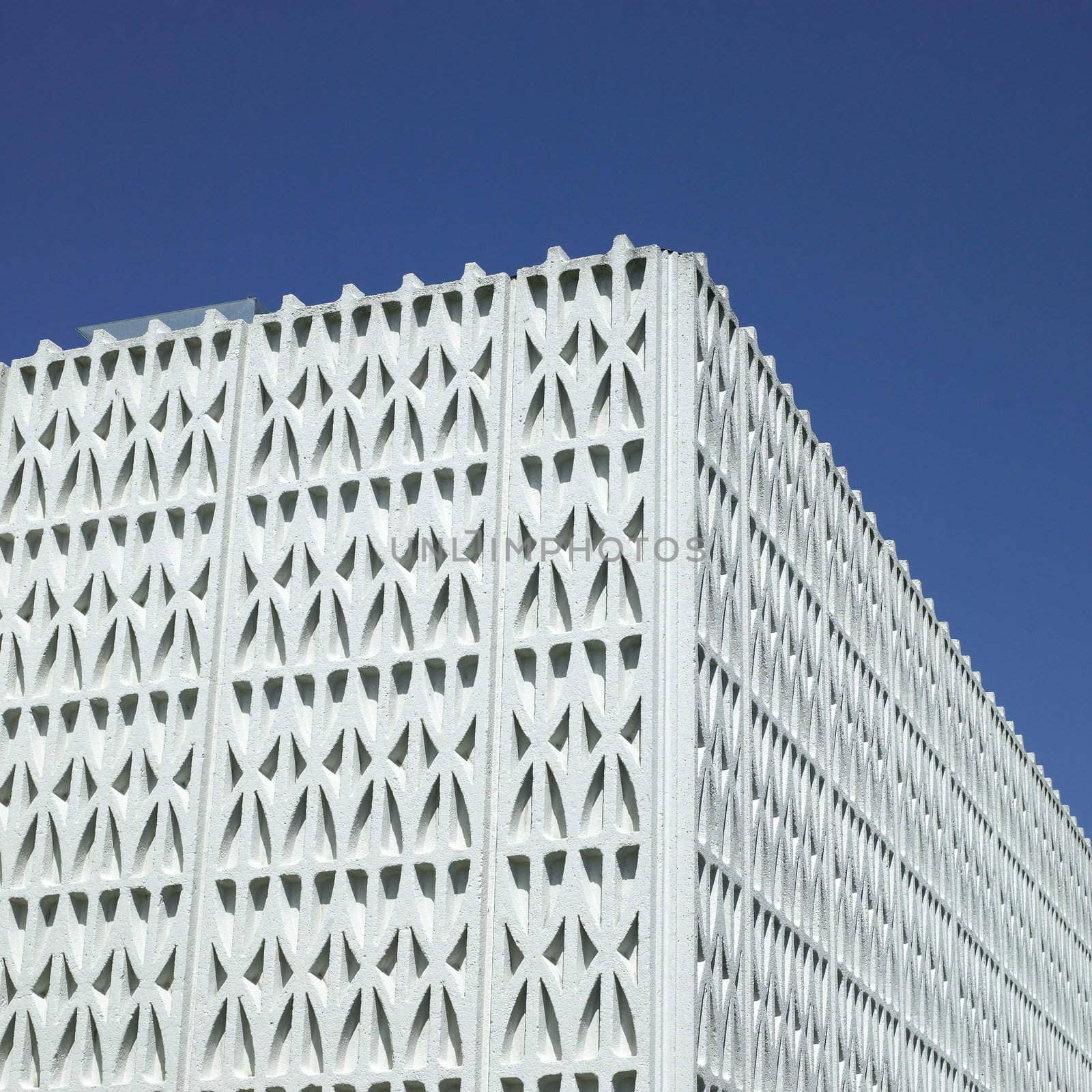 Patterned wall and blue sky
