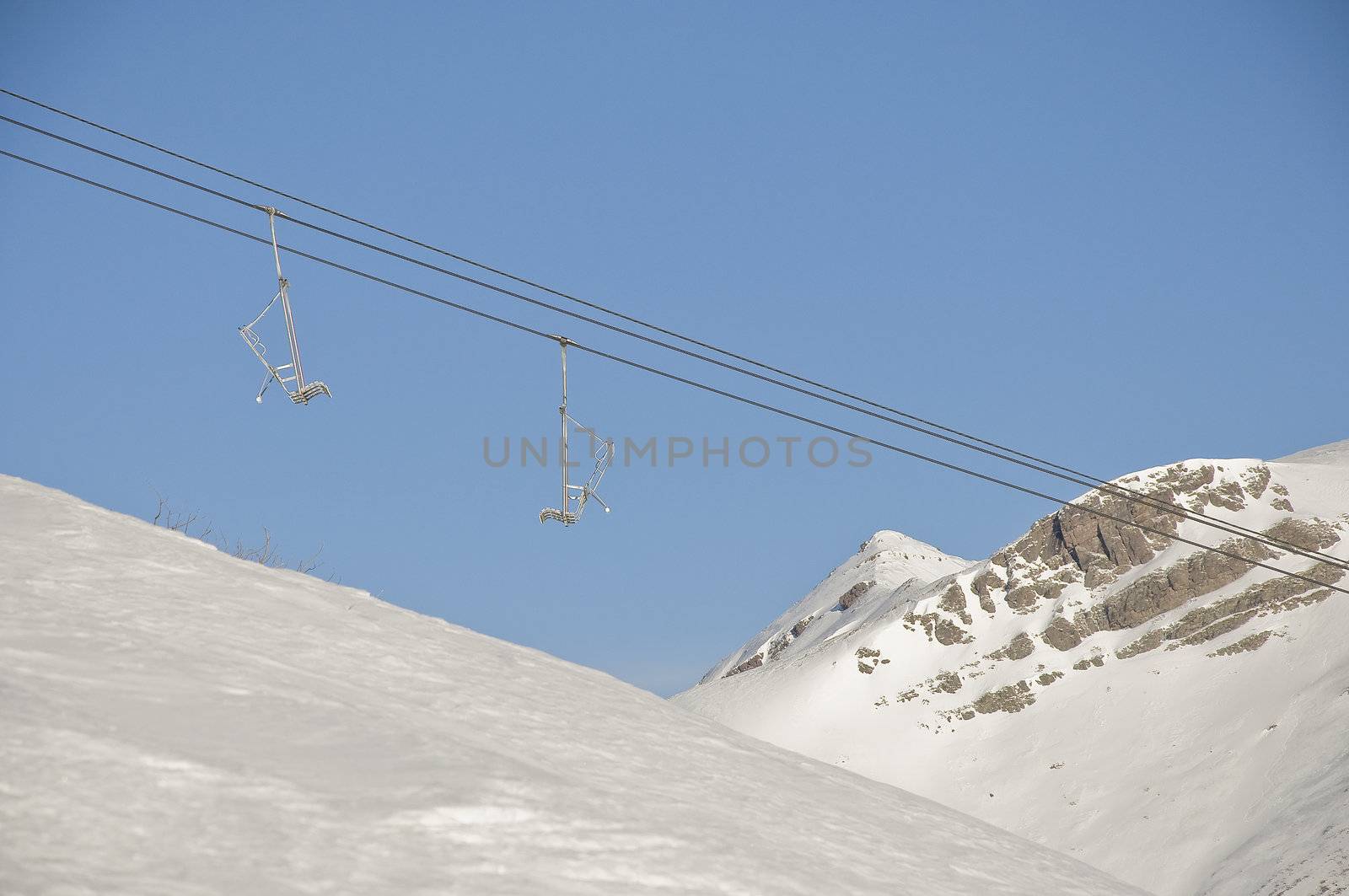 chair lift in the snow by sognolucido