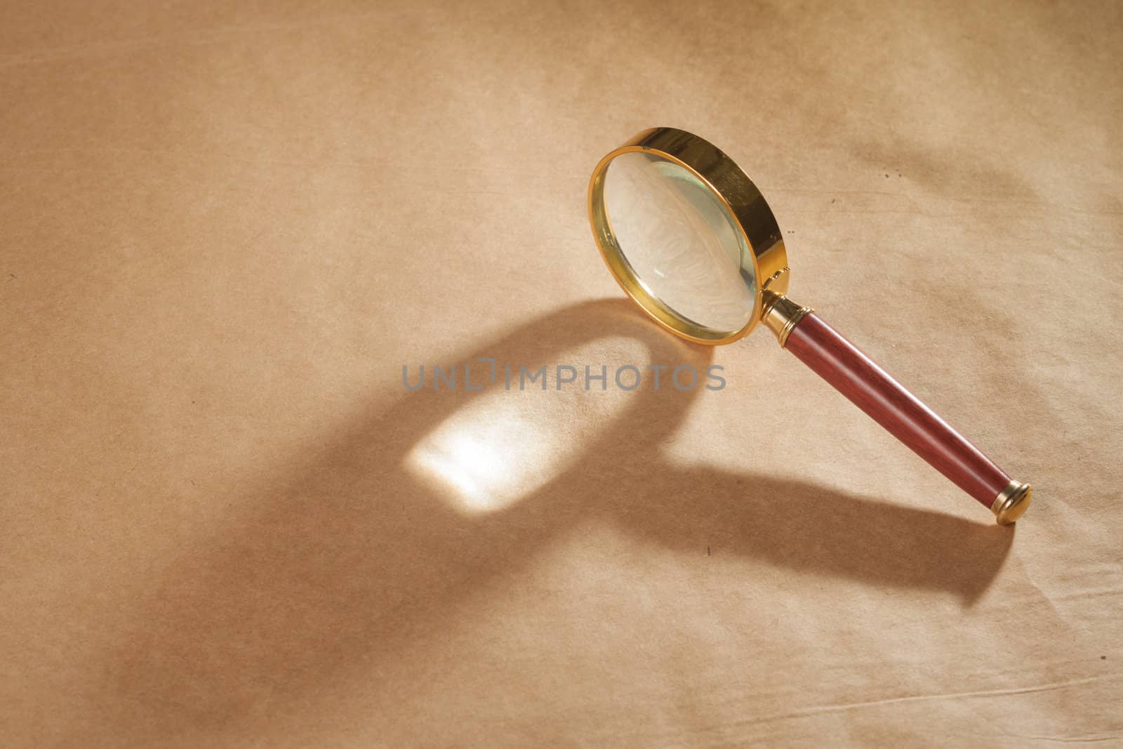 Magnifying Glass on Brown Background by Daniel_Wiedemann