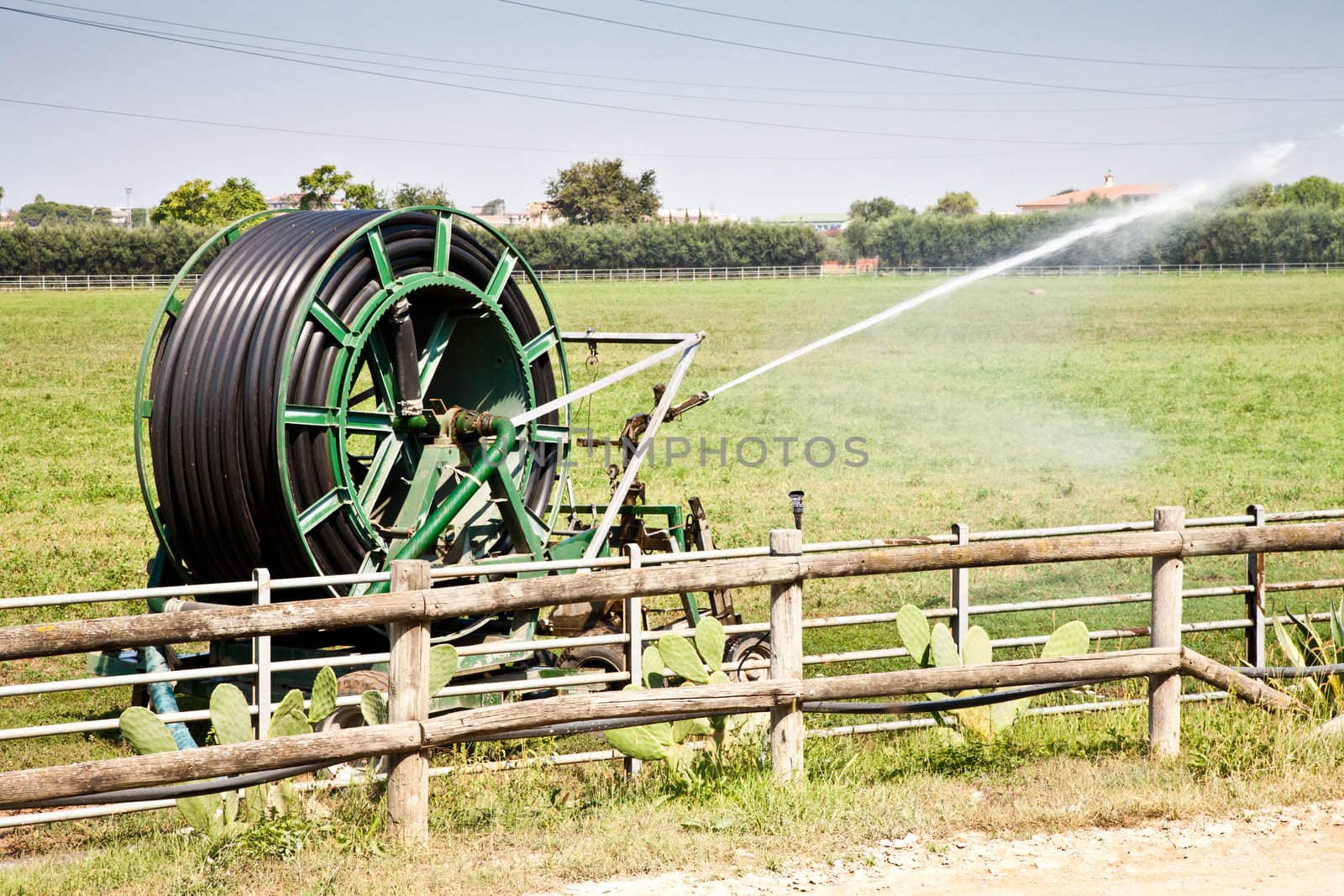 Irrigation operations in Italian country during a sunny day