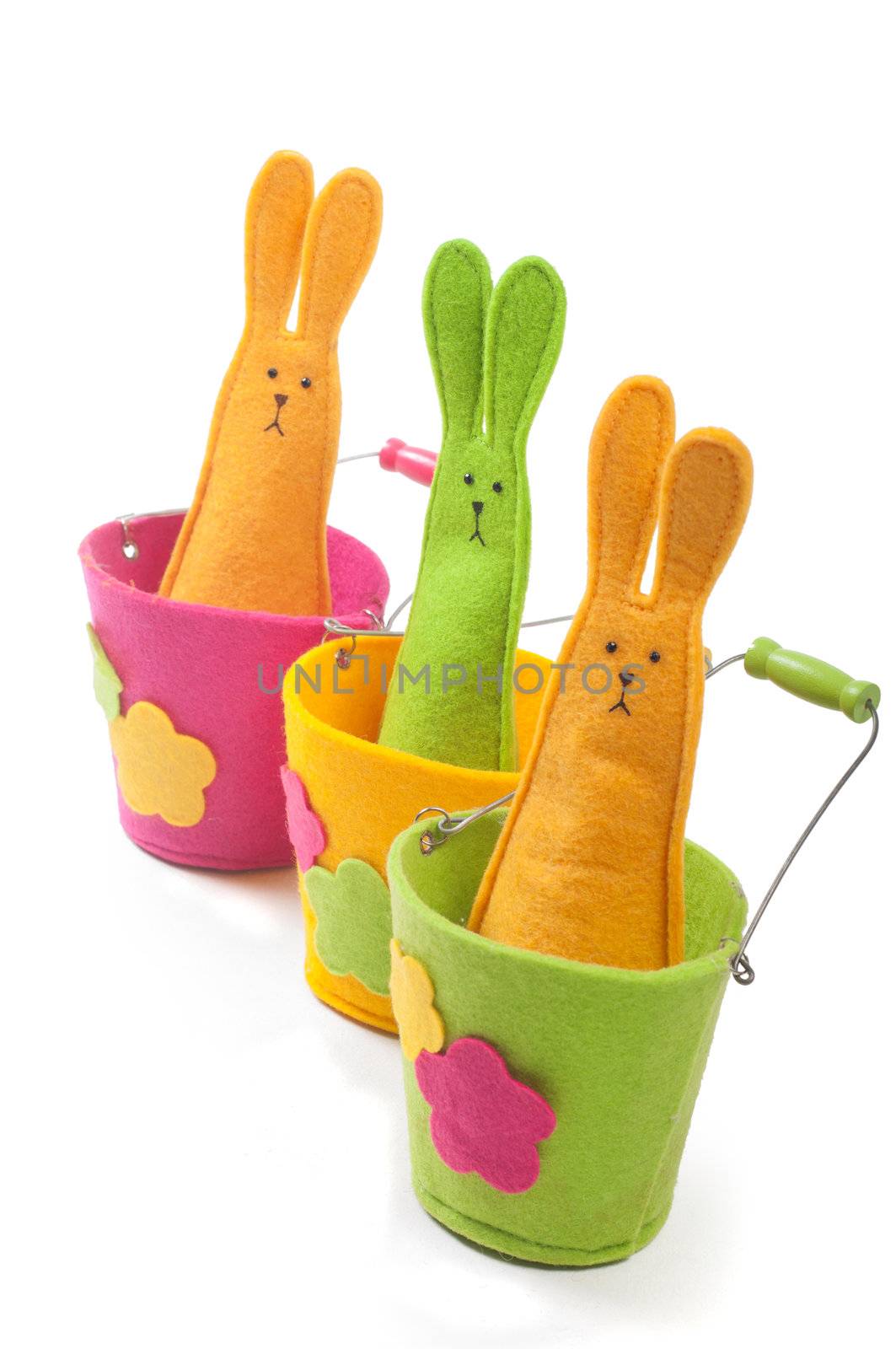 Multicolored easter bunnies sitting on the pots