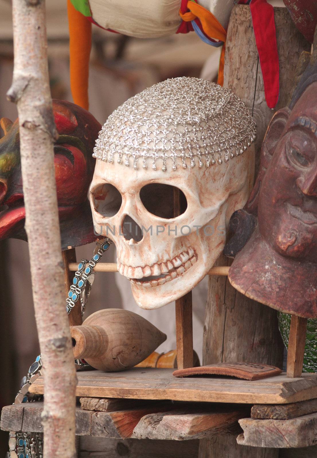 Scull for sale in a market stand among other stuff.