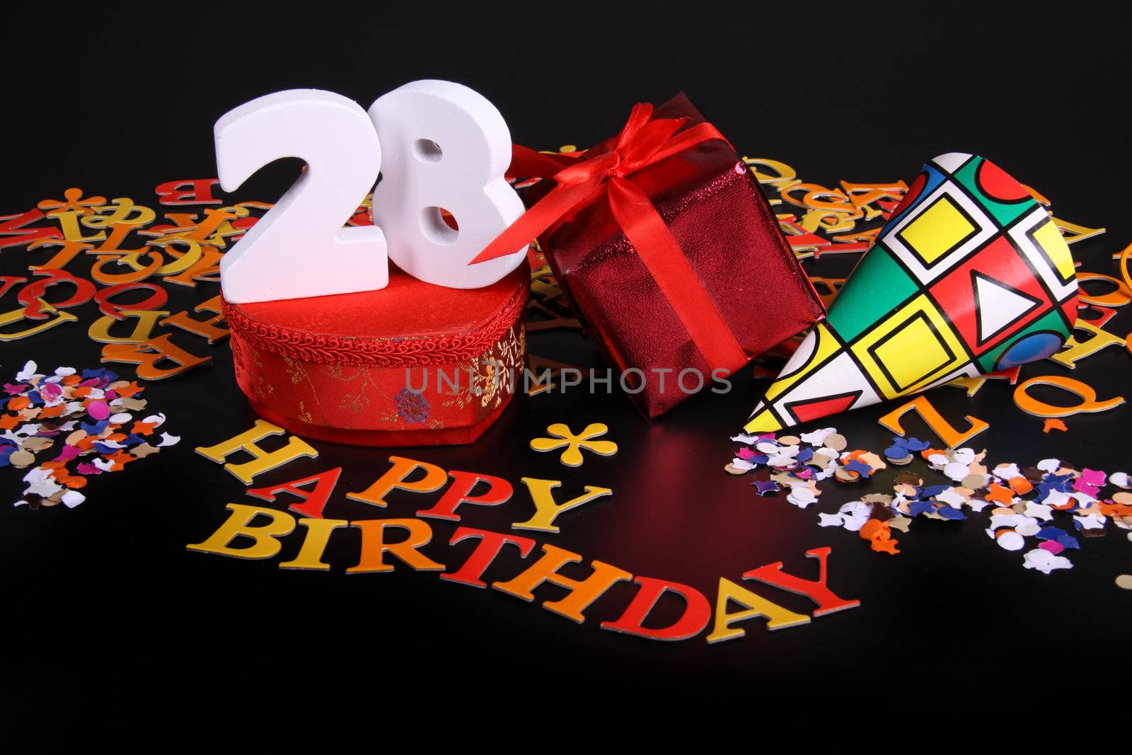 Happy birthday on a black background  and a red heart  and white caracters and confetti