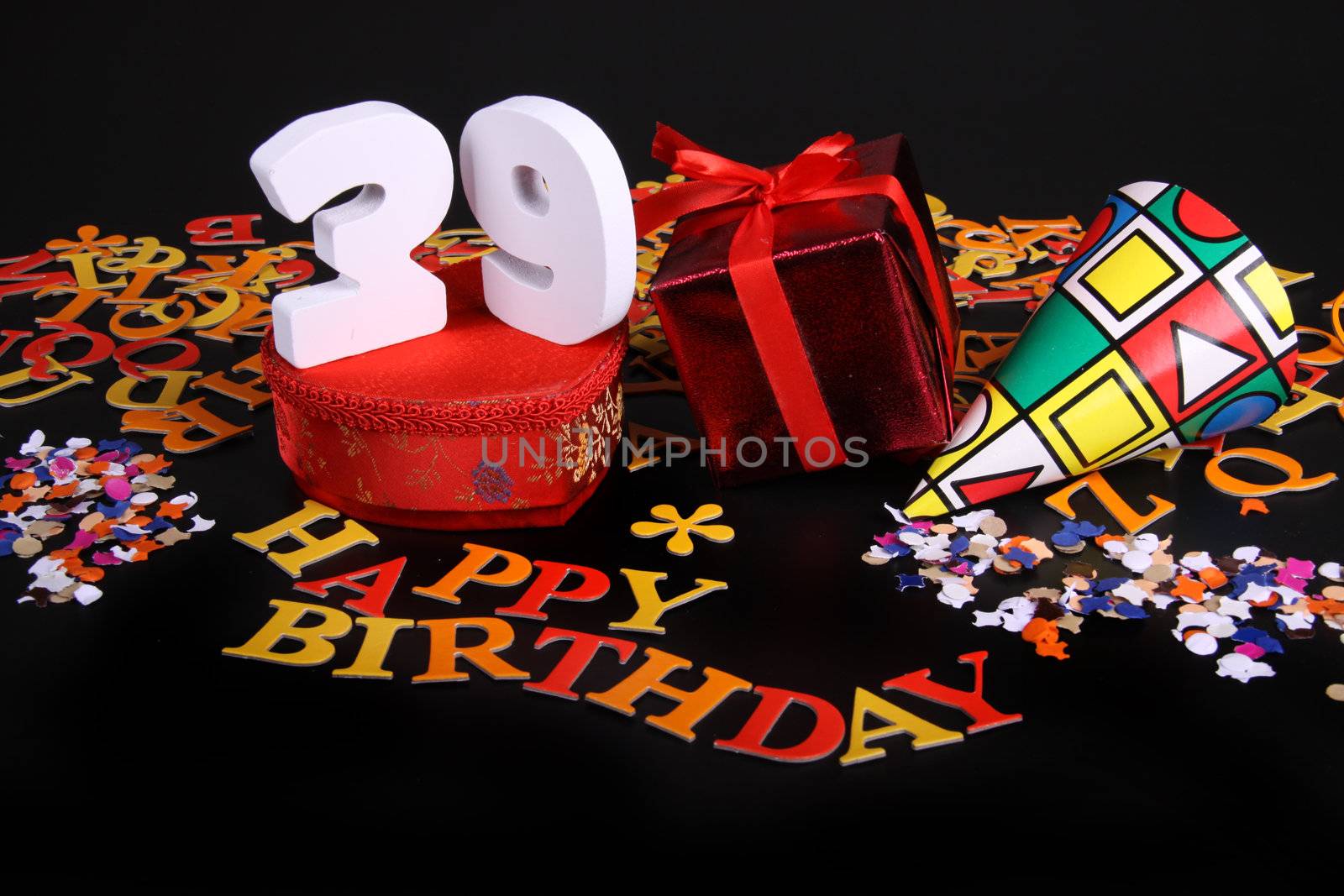 Happy birthday on a black background  and a red heart  and white caracters and confetti