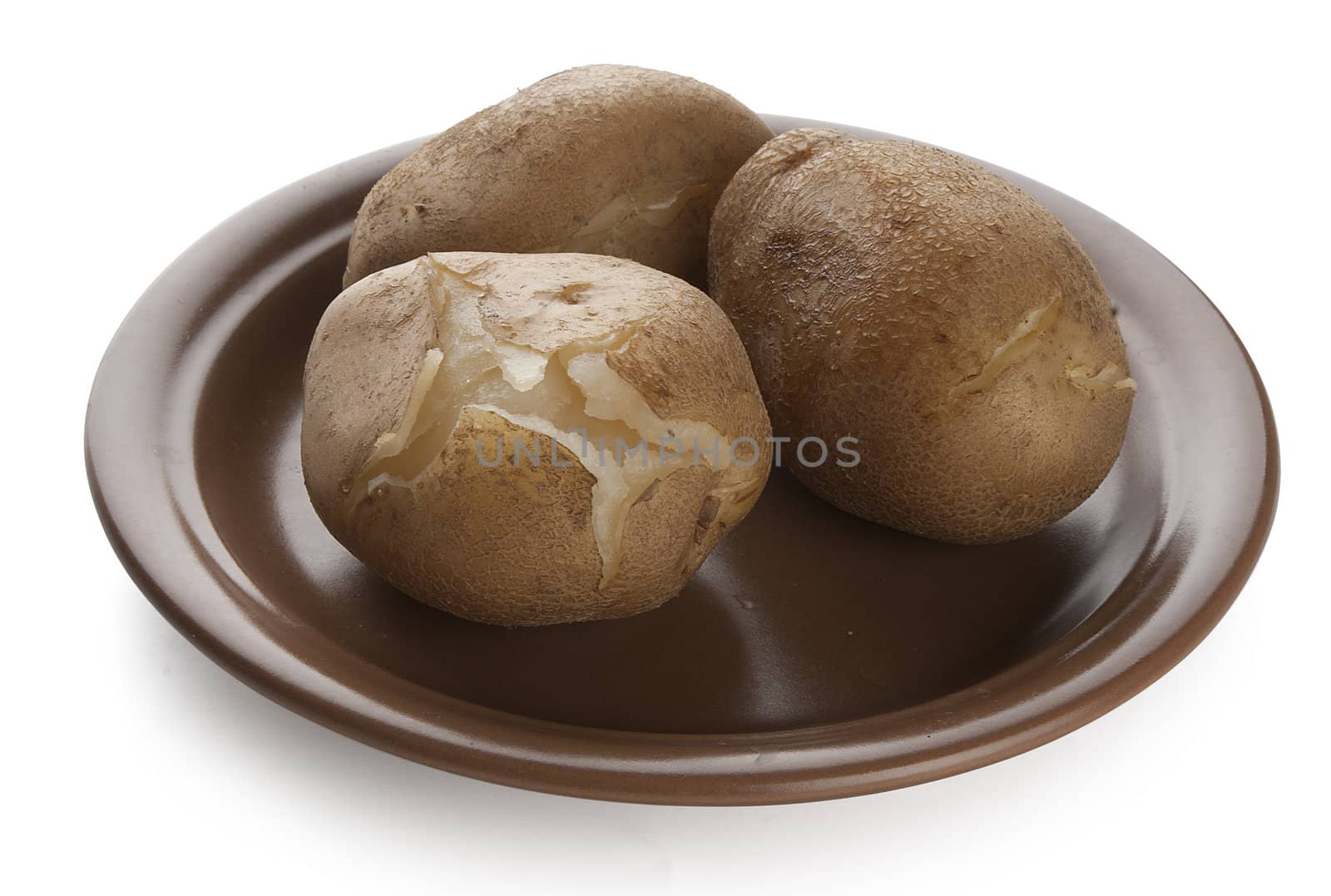 Potatoes boiled in their jacket on the brown plate