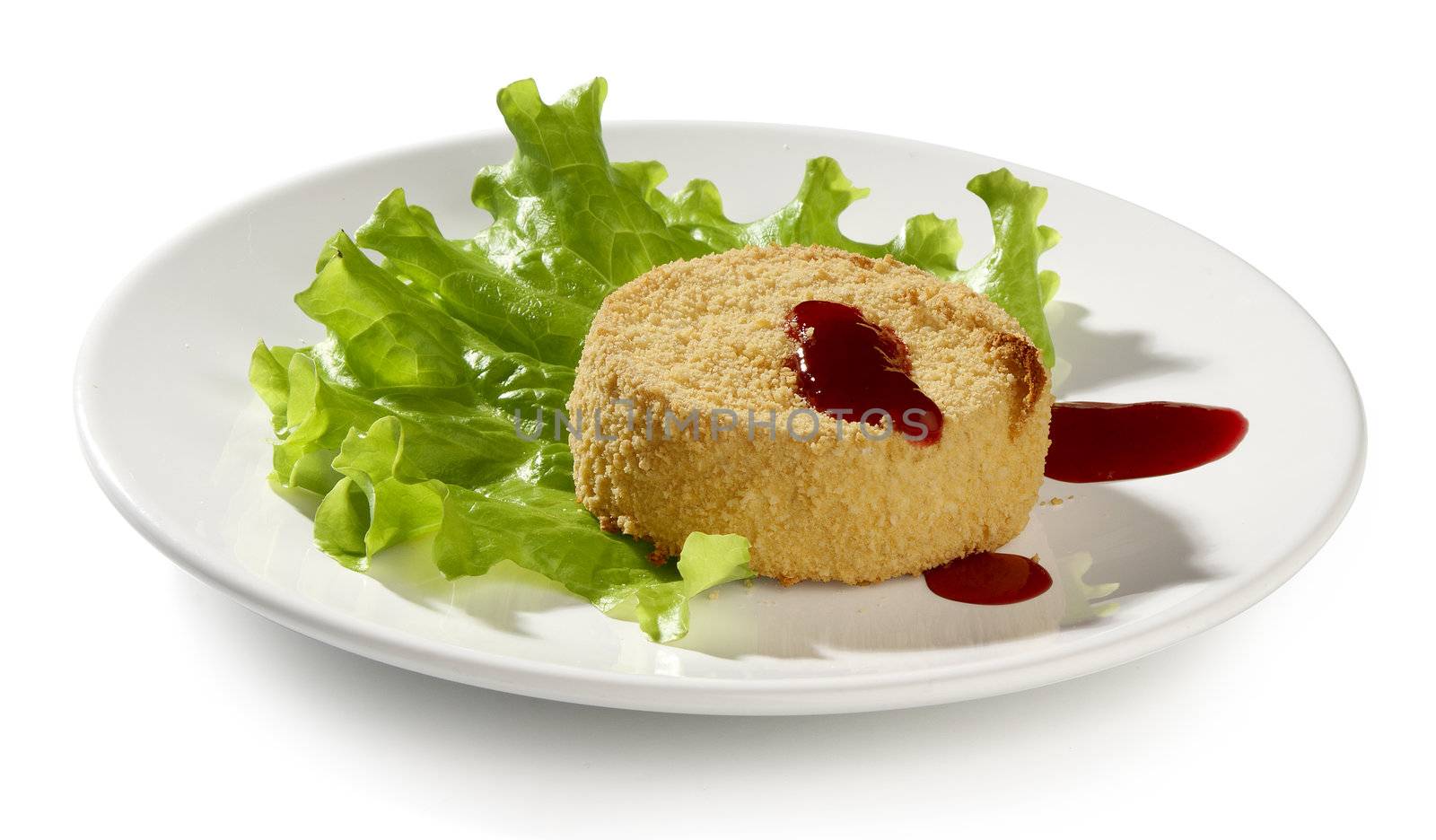 Baked camambert coated with breadcrumbs with lettuce and cowberries jam on the plate