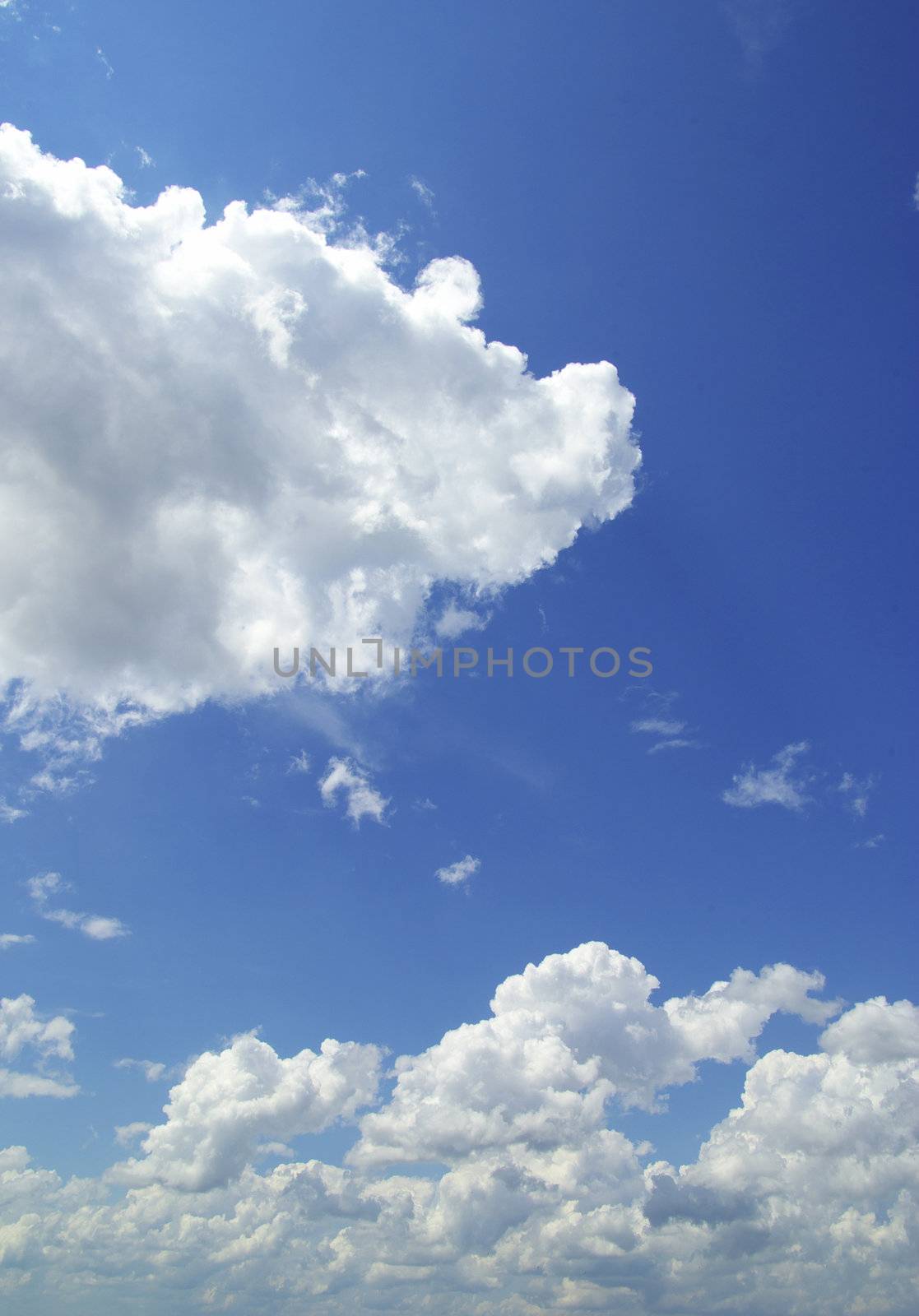 Blue sky background with tiny clouds