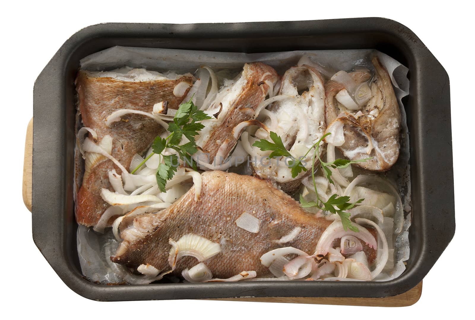 Baked pieces of rosefish in the roasting pan