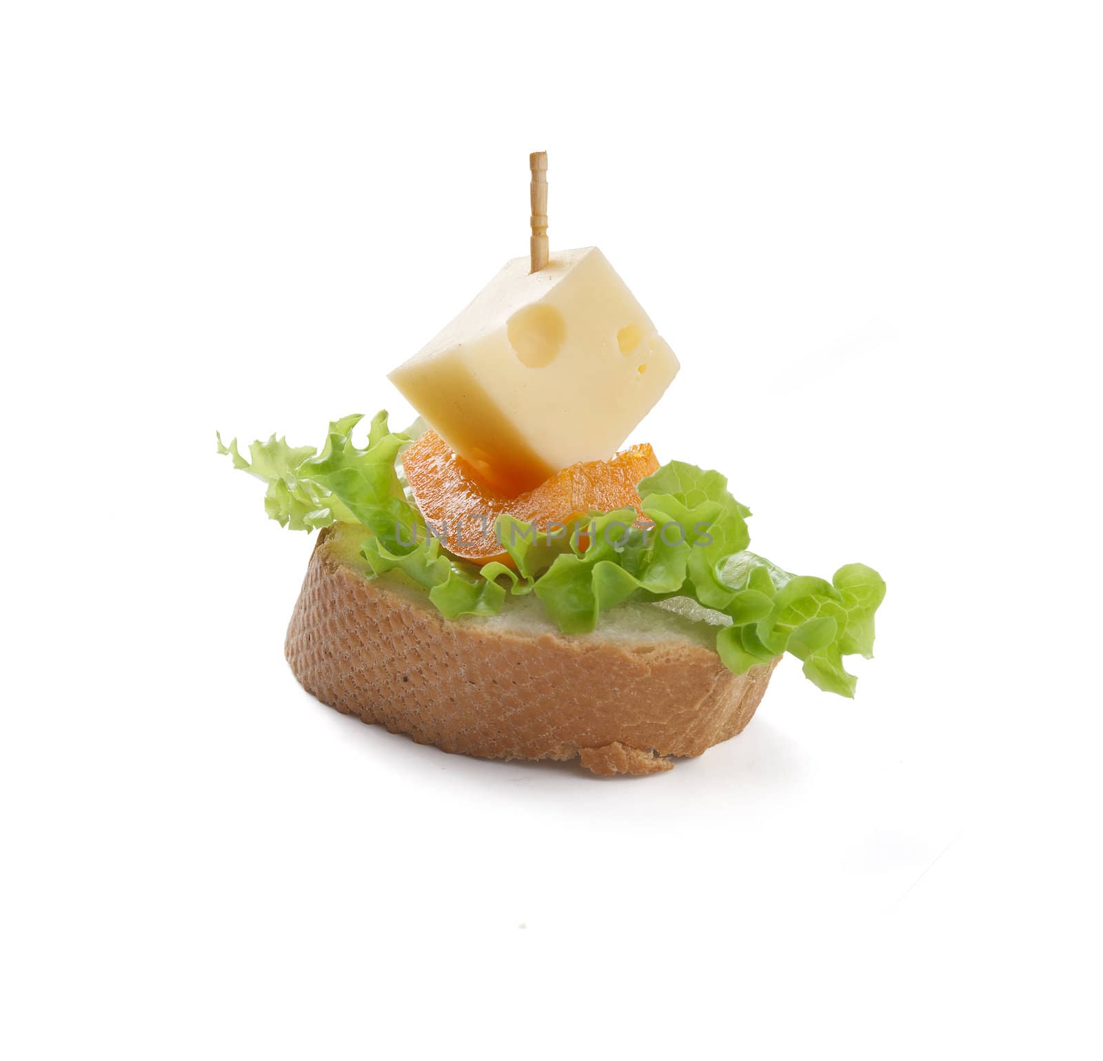 Canape with ham, paprika, lettuce and cheese on the white