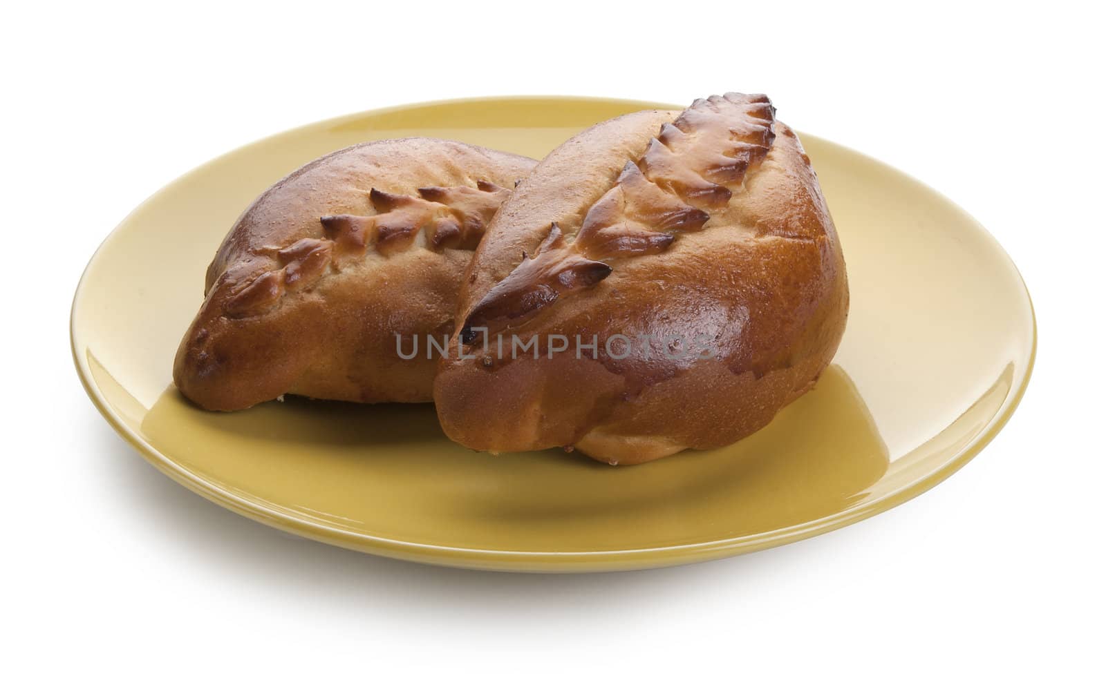 Two baked pasty on the yellow plate