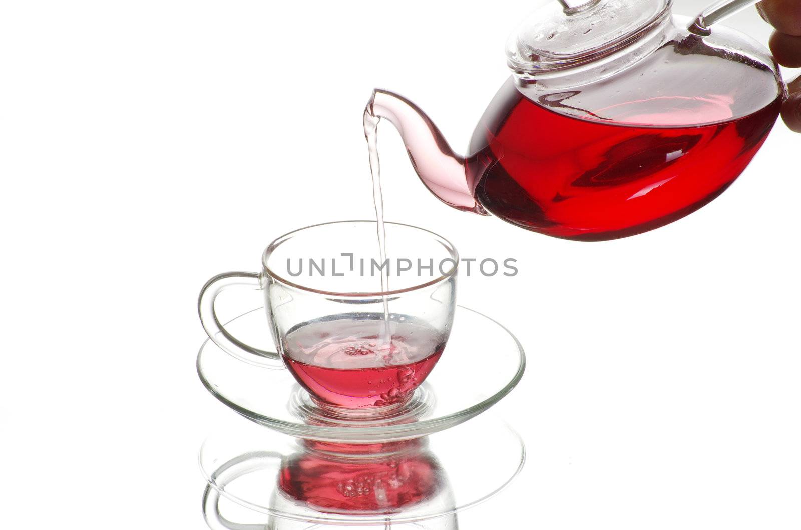 Tea being poured into glass tea cup