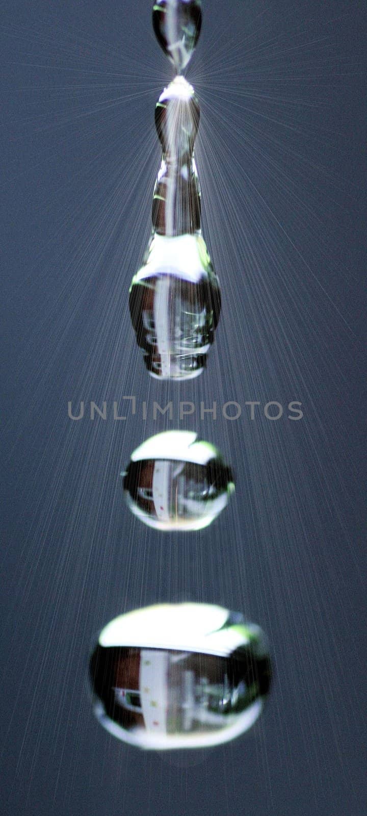 Macro of water drops from a Faucet