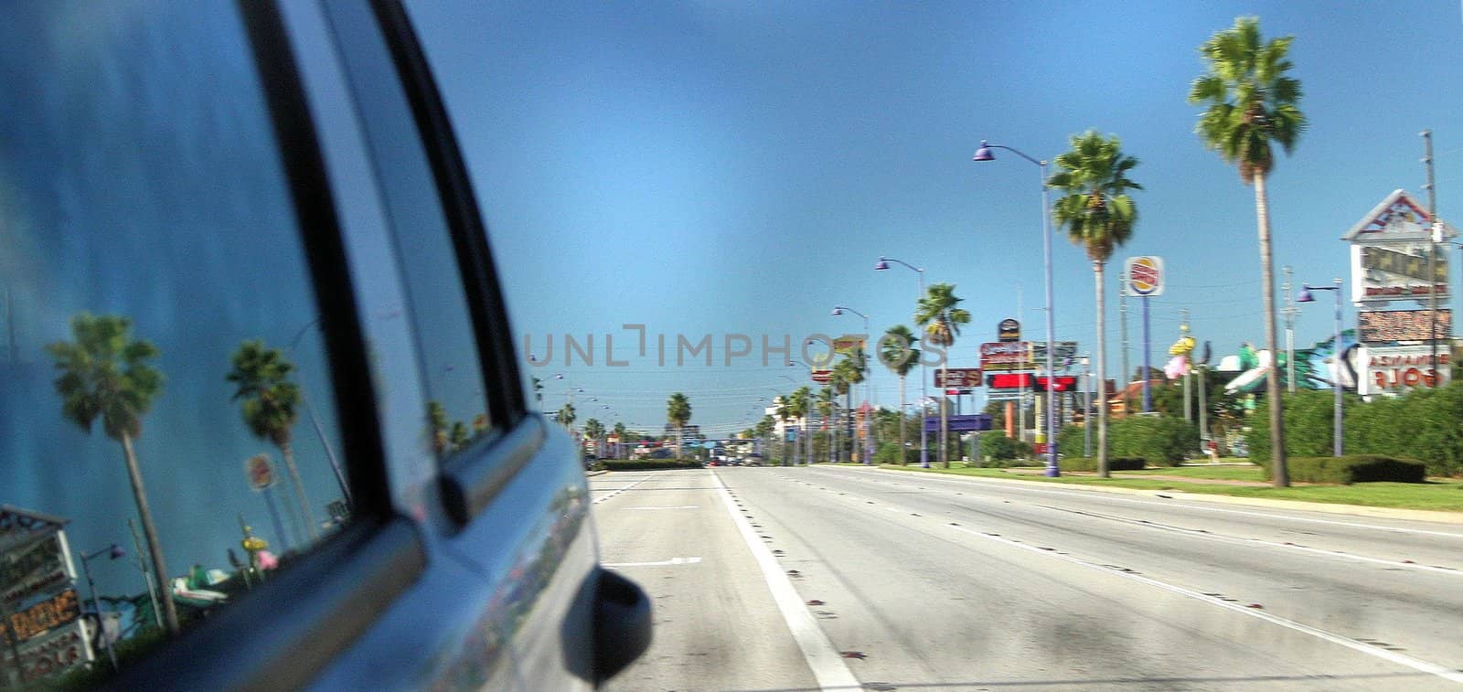 A car traveling along a quiet road in Florida.