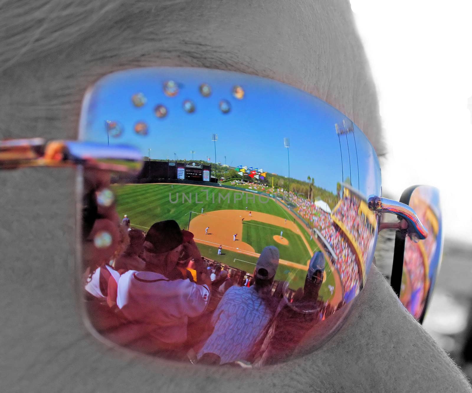 A baseball game reflected in the sunglasses.