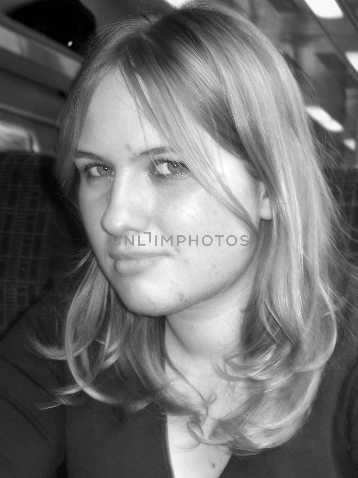 Victoria posing on a train in black and white.