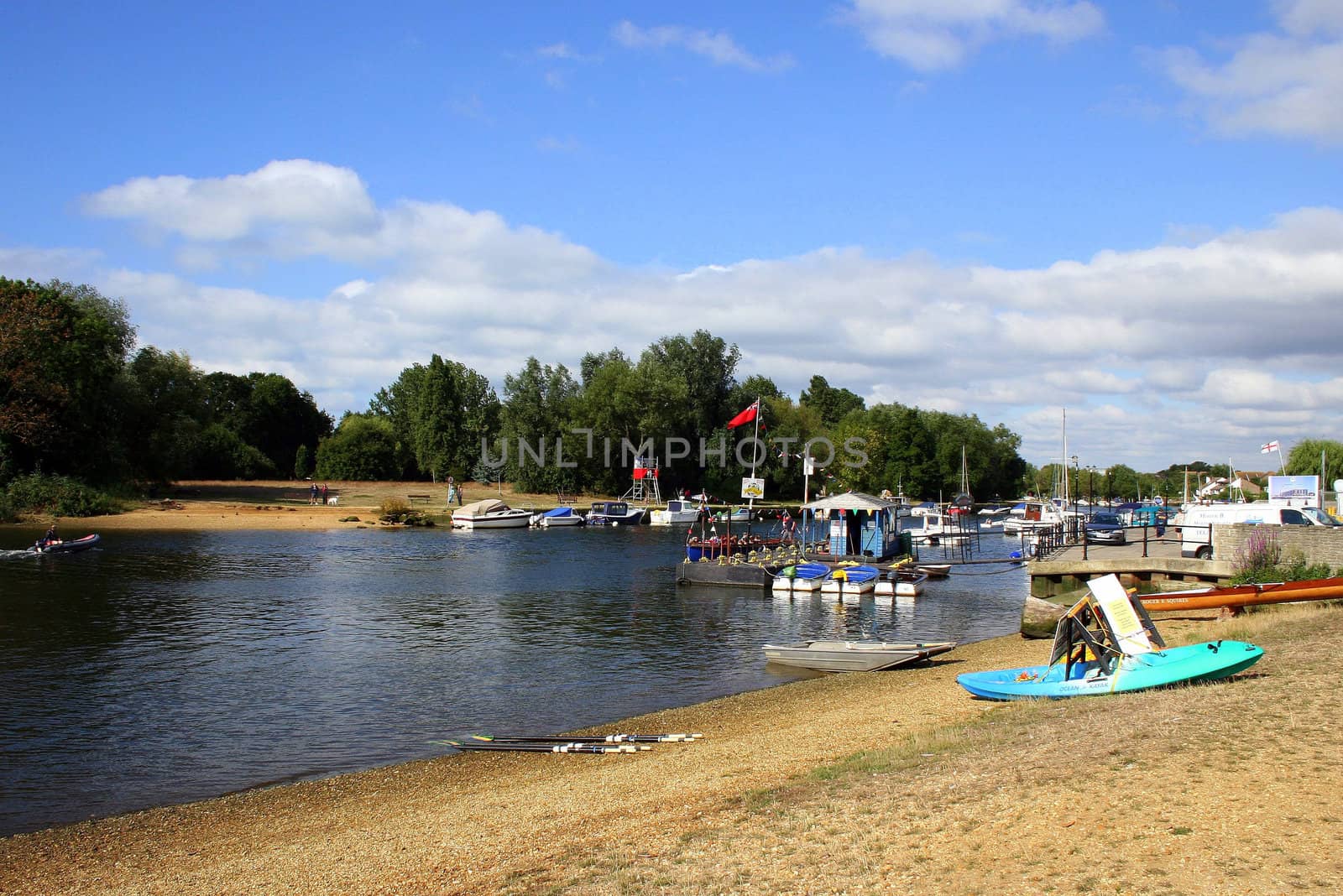 Christchurch river at a regatta with boats and sand.