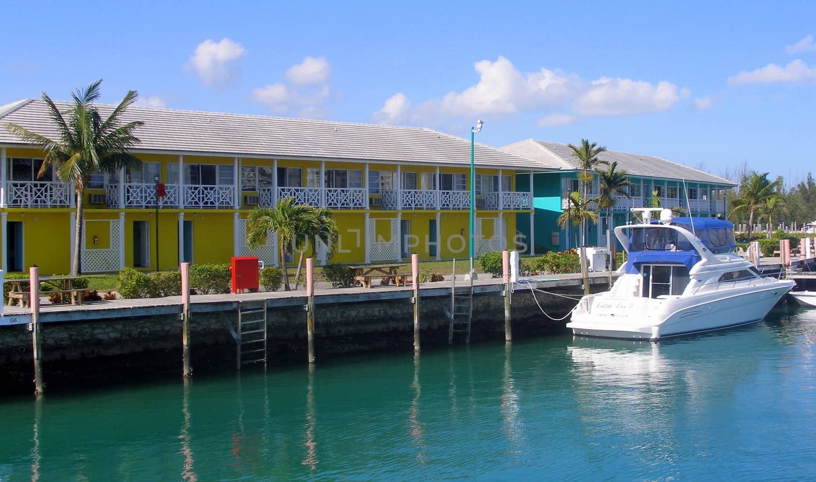 Colorful waterfront houses in the Bahamas and a boat.