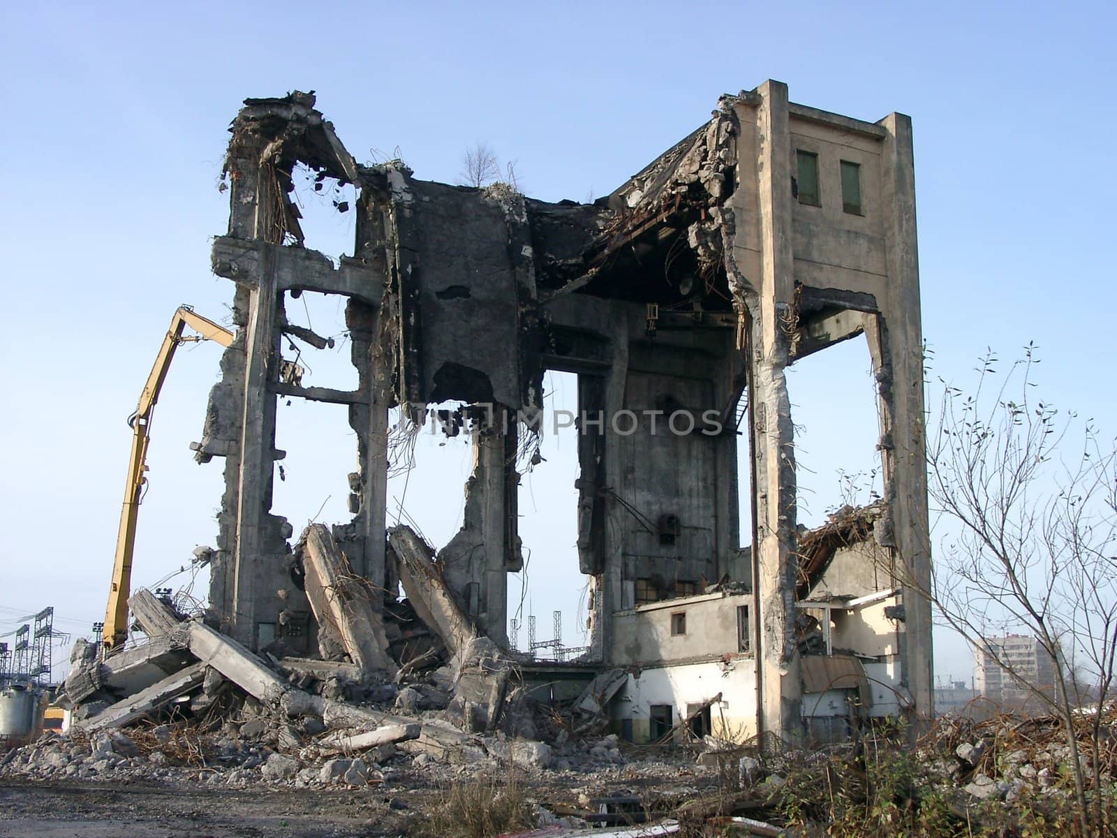 View of demolition works on high industrial building at sunny day.