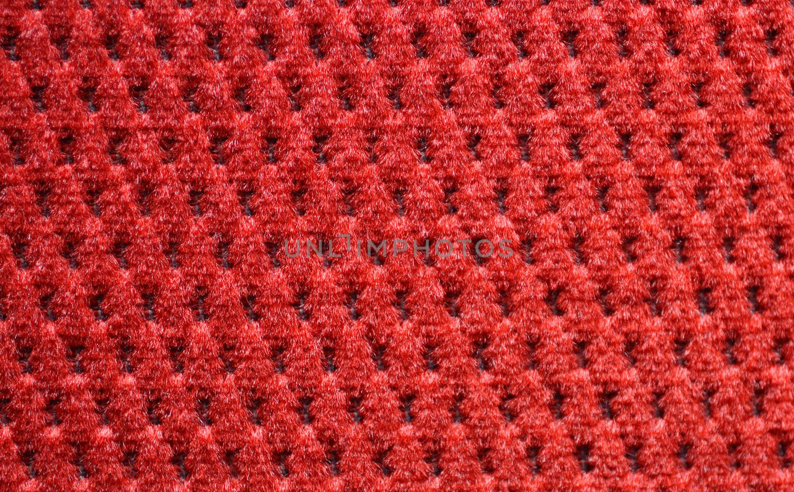 red upholster material of armchair close-up
