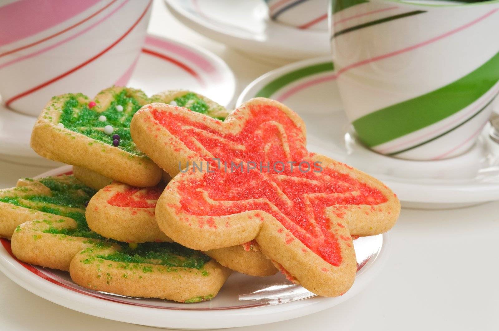 Plate of colorful christmas sugar cookie shapes.