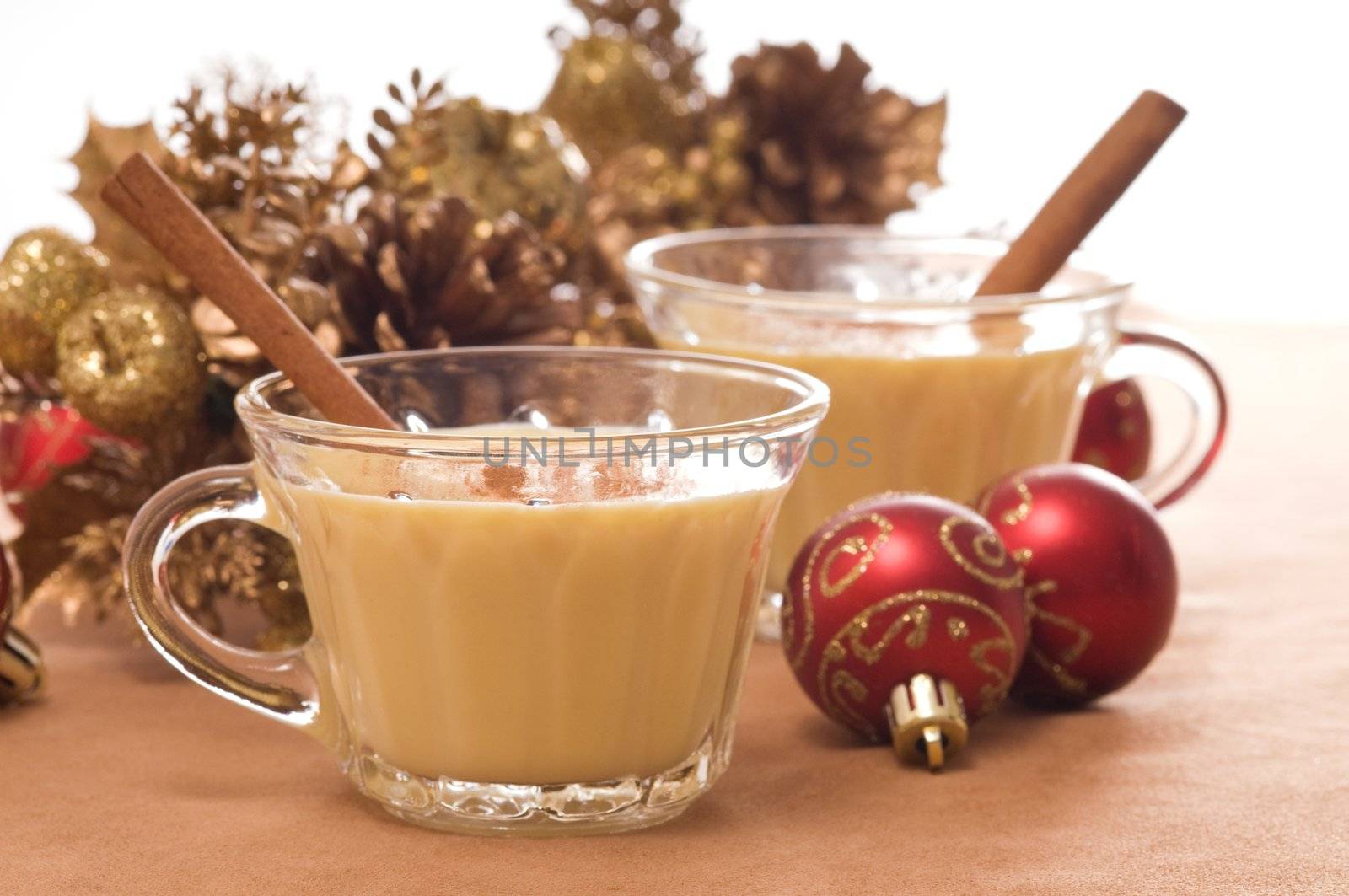 Glasses of festive eggnog with christmas decorations.