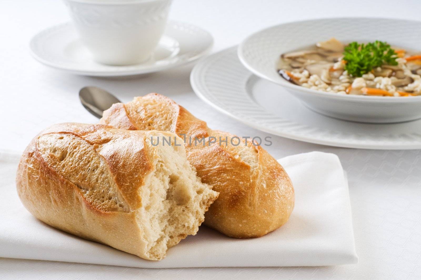 Fresh baked french baguette accompanying hot soup.