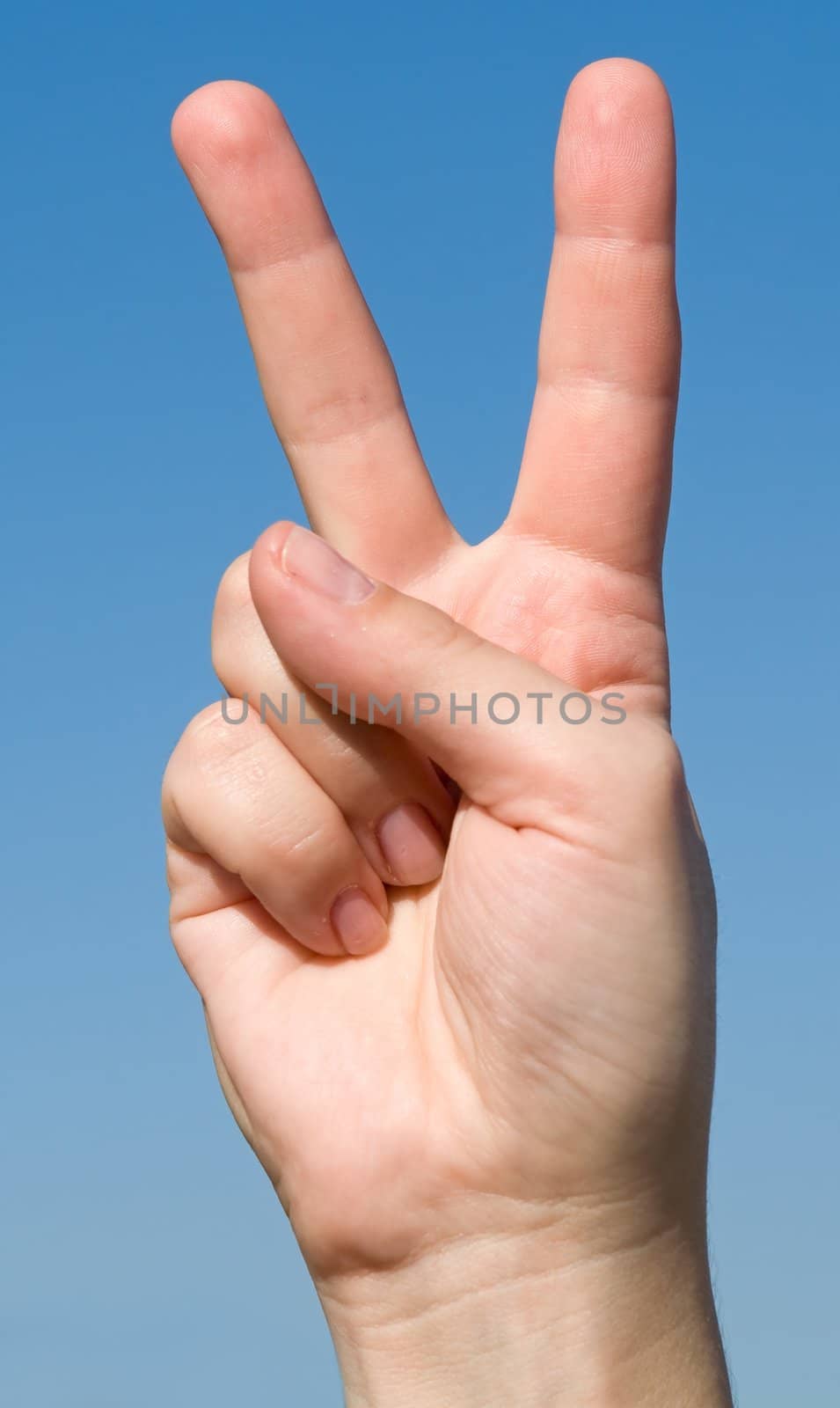 Victory sign with blue sky behind