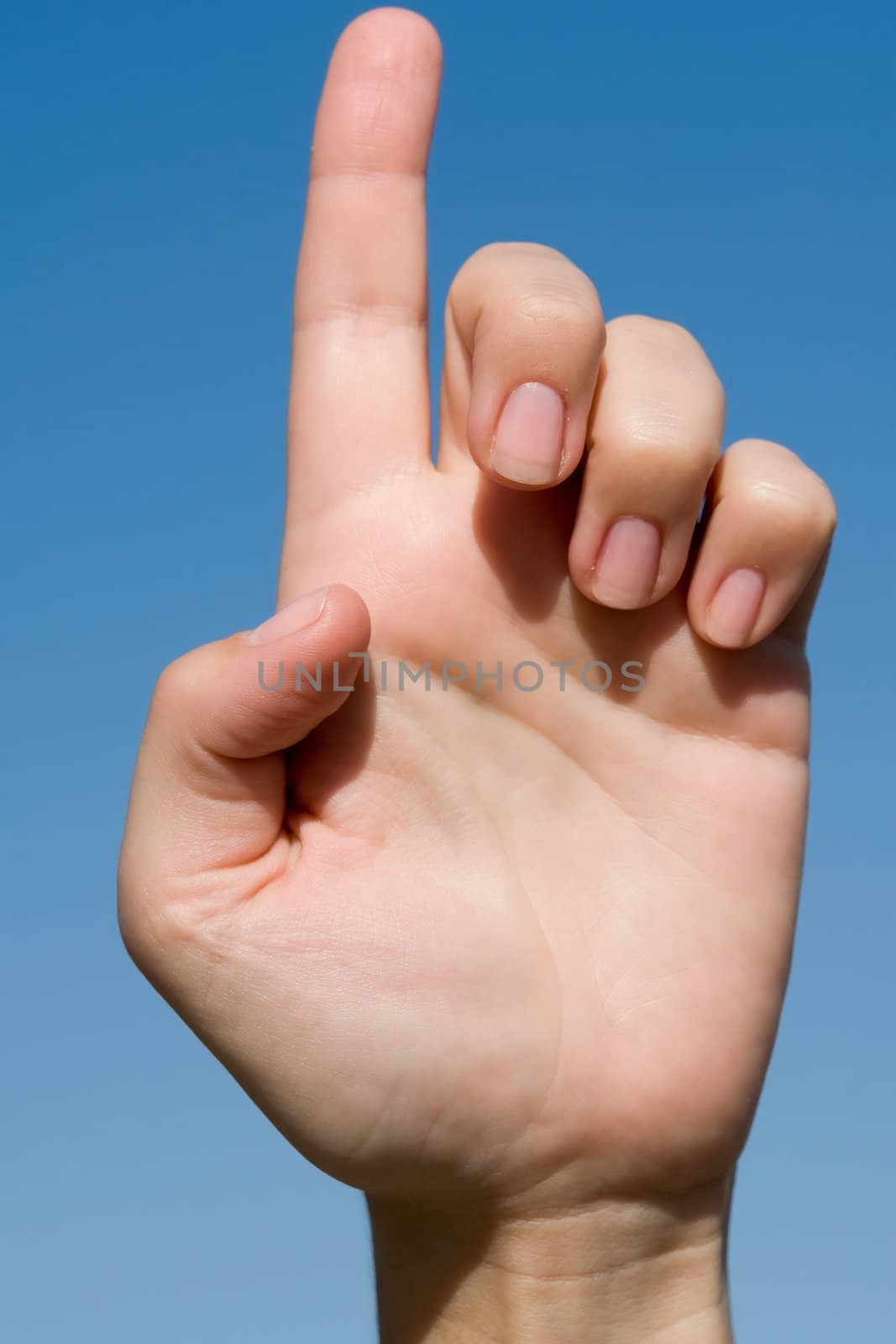 one. Human hand on a blue sky