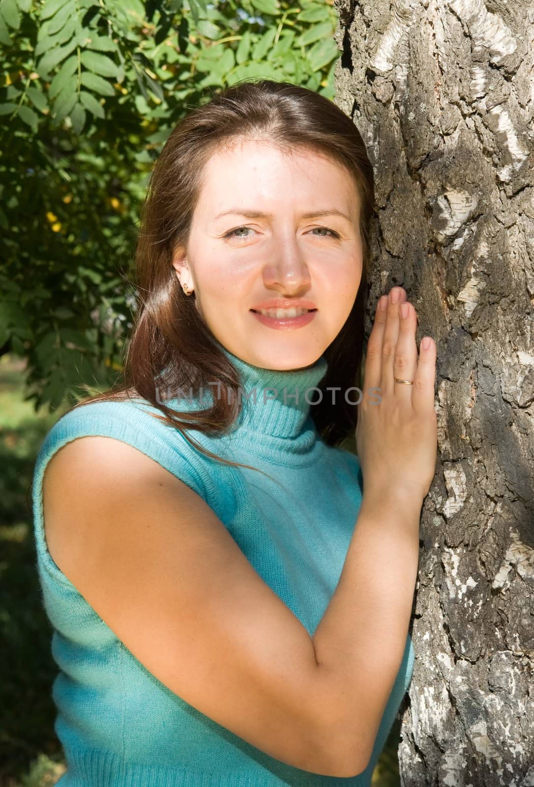 Portrait. The beautiful young woman near a birch.