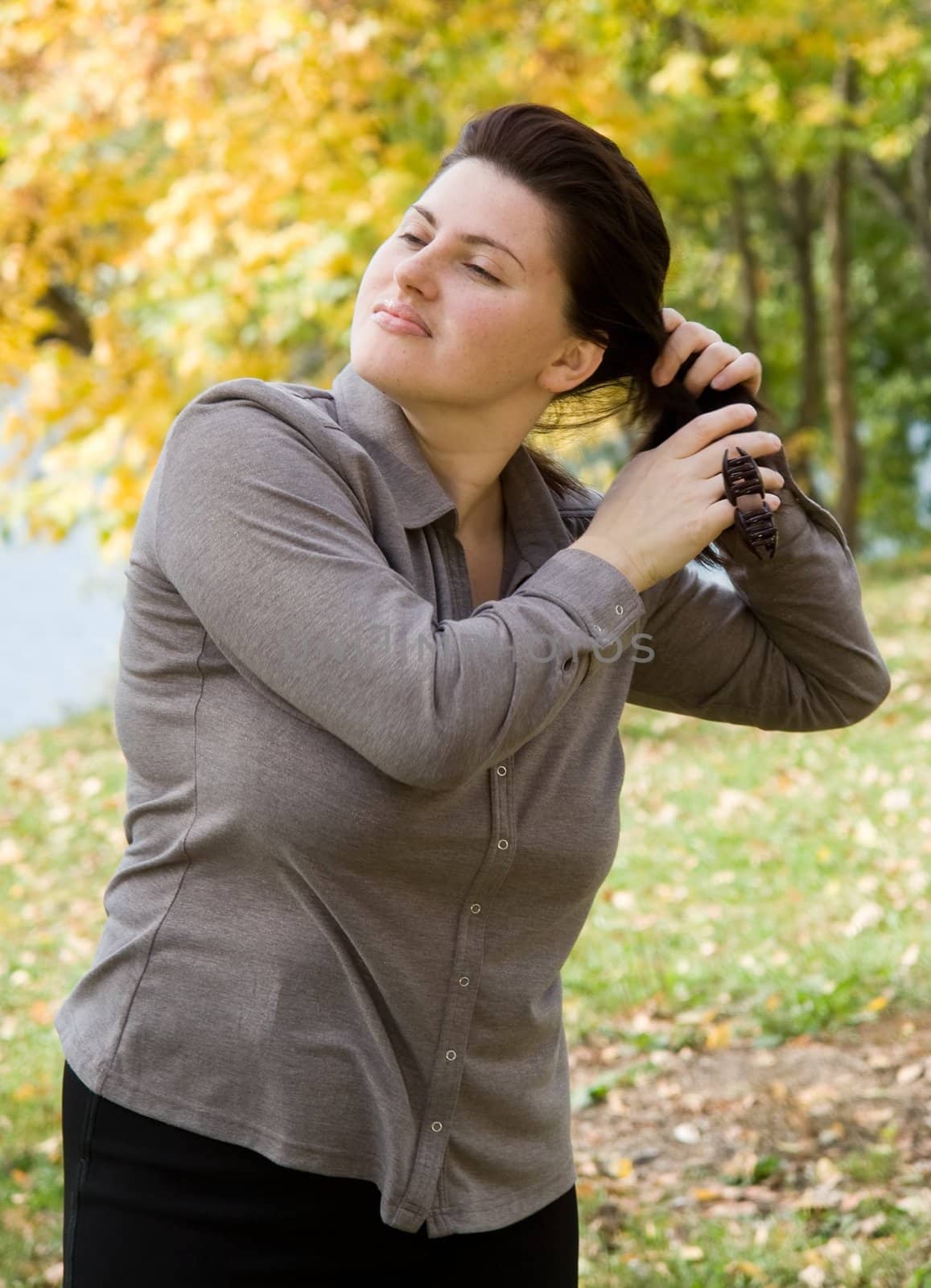 The beautiful young woman corrects a hairdress.