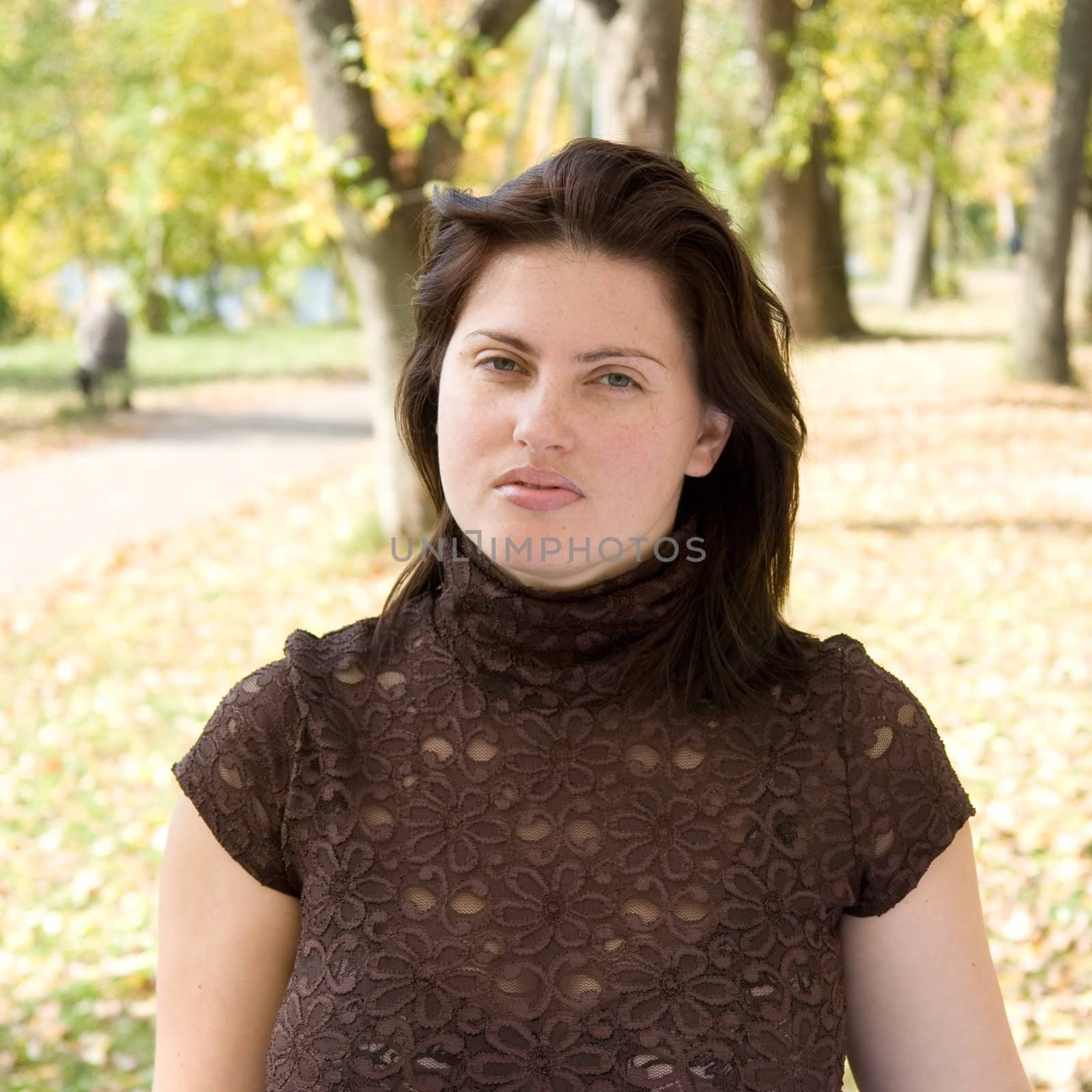 Autumn. Beautiful young woman against yellow leaves.