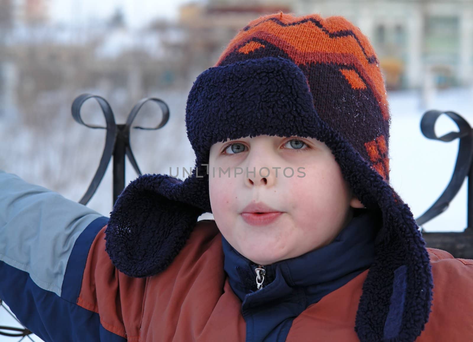 Whistle. The little boy in a winter cap.