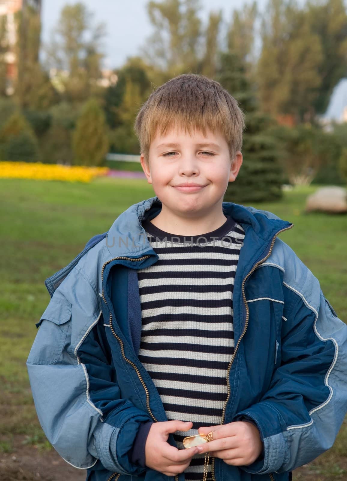 The happy little boy in green park