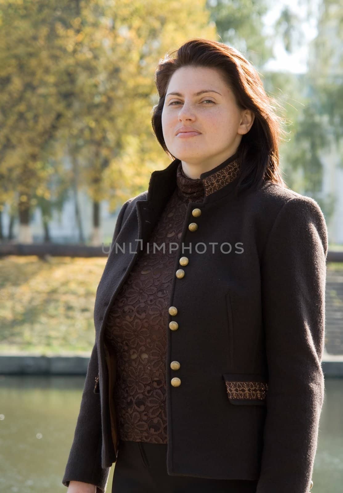 The beautiful young woman against the river