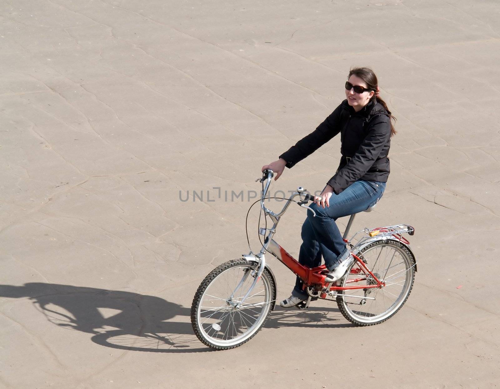 The young beautiful woman on a bicycle
