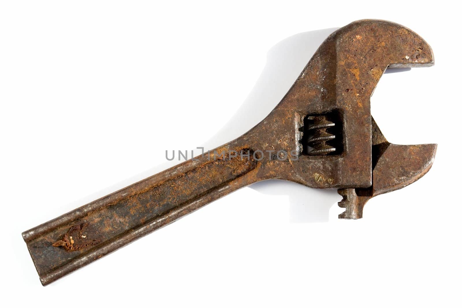 Old adjustable spanner on a white background