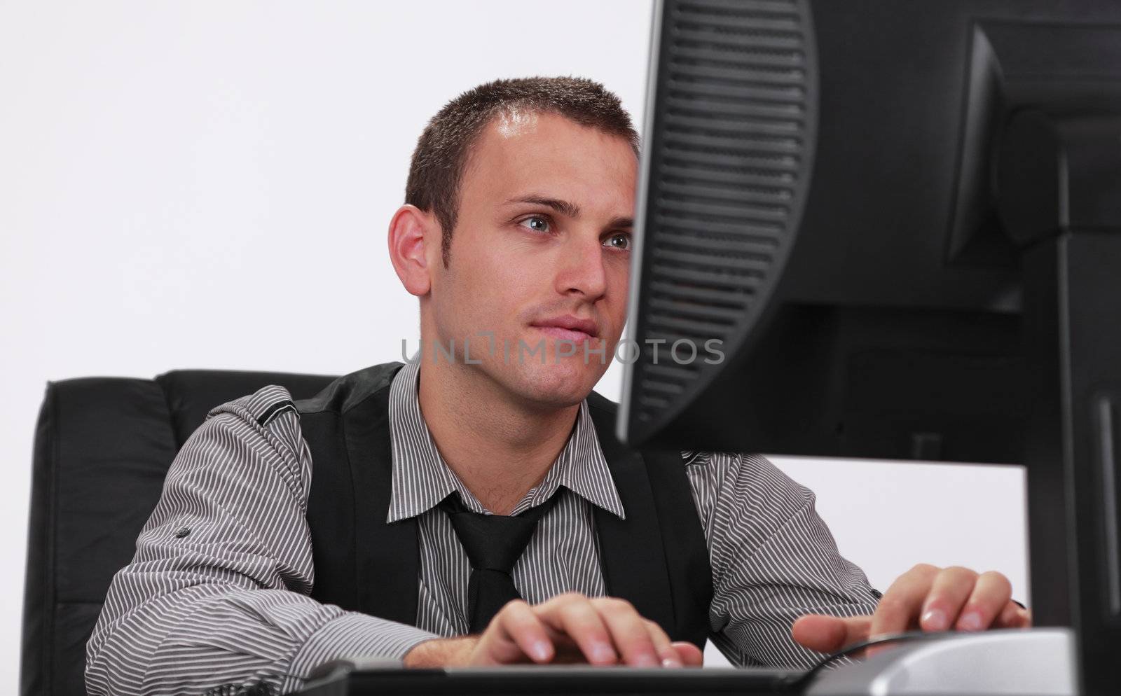 Image of a young businessman working on his computer.