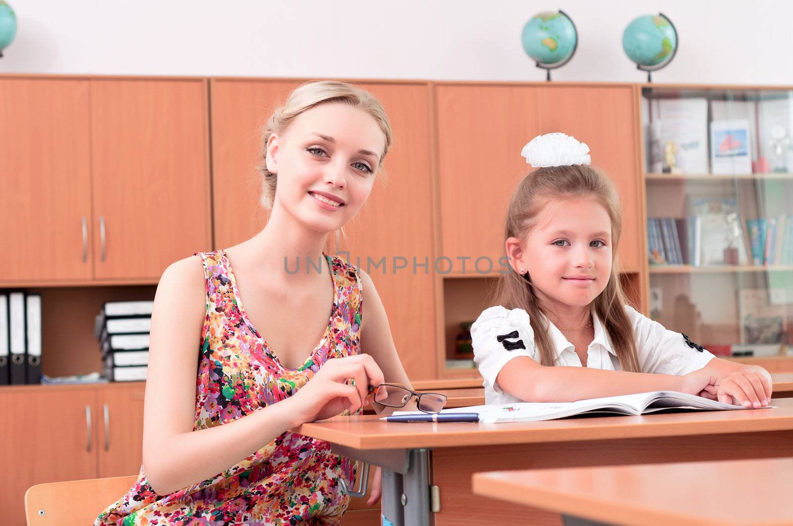 teacher sitting near pupil by adam121