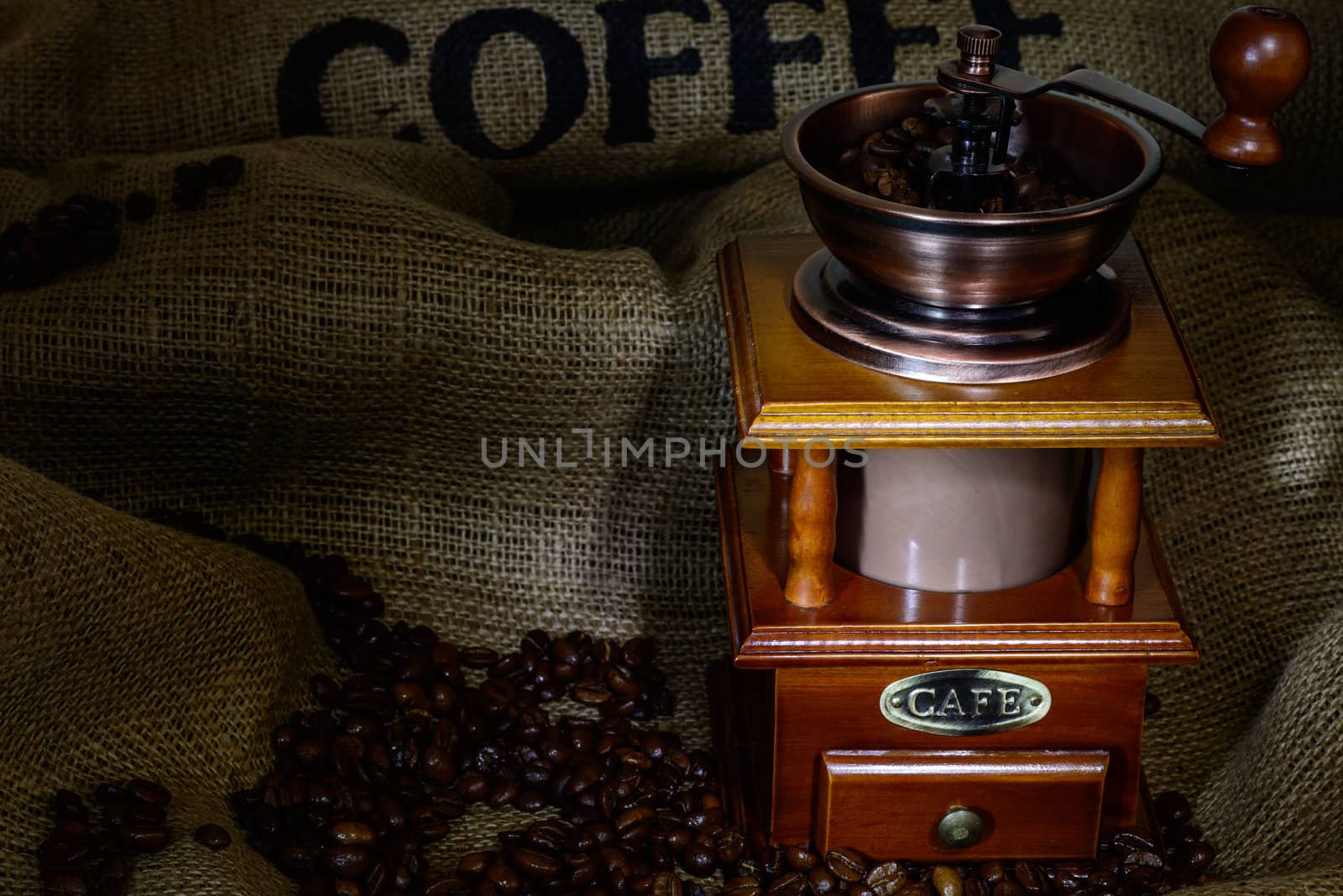 Coffee Mill with beans and burlap. still life