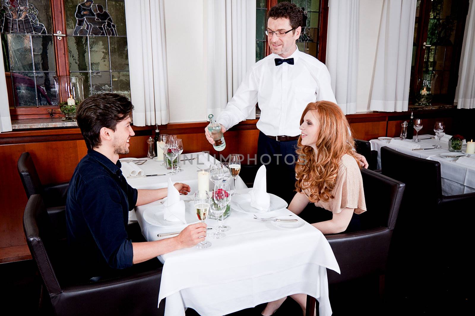 man and woman for dinner in restaurant by juniart