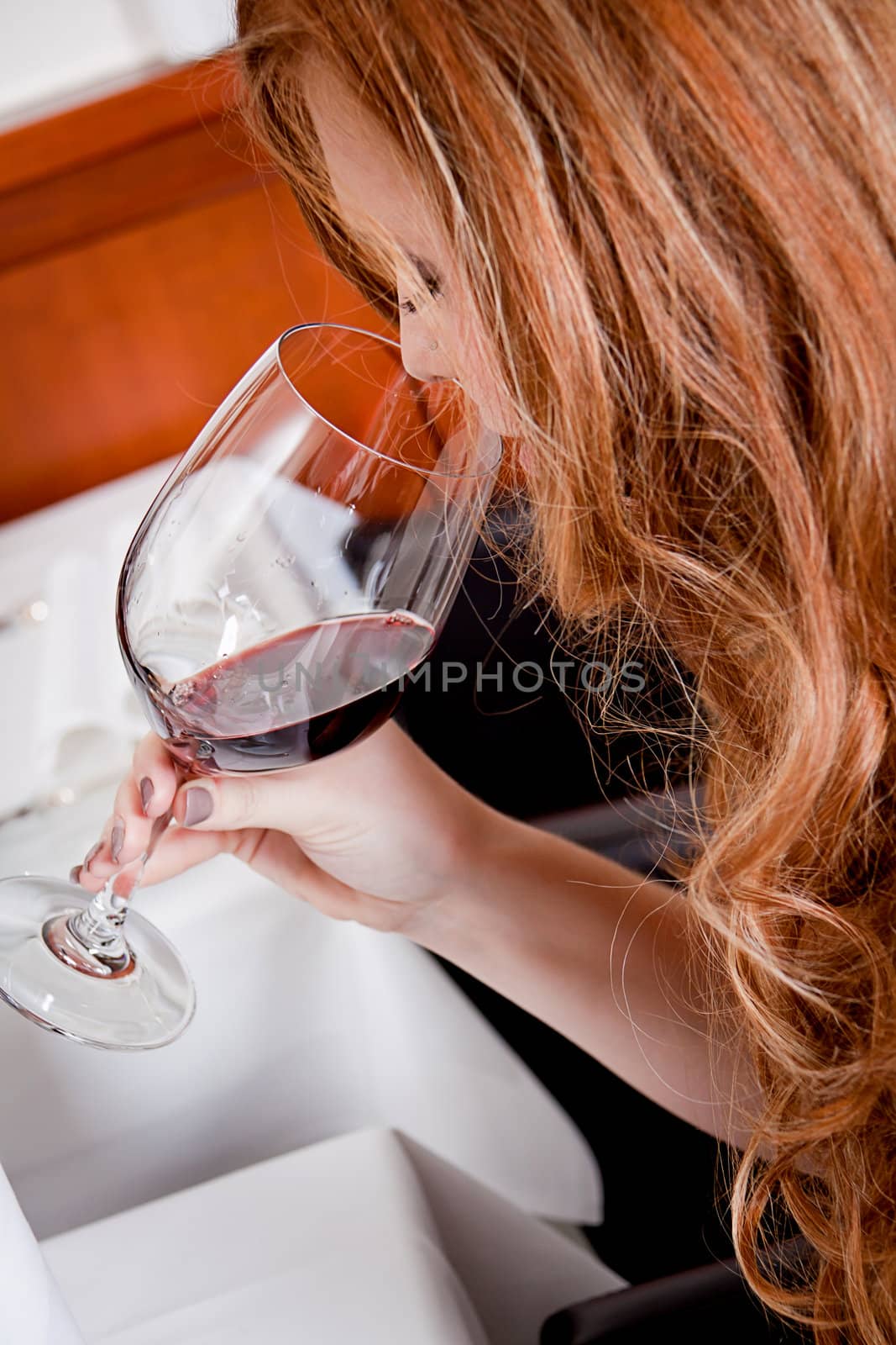 man and woman in restaurant for dinner drinking red wine and smiling